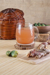 red ginger and areca nut brewed drink photographed in a studio setting with traditional Indonesian theme props