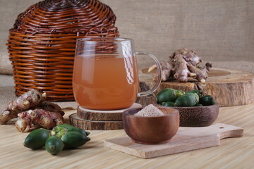 red ginger and areca nut brewed drink photographed in a studio setting with traditional Indonesian theme props