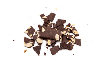 Crispy cracker snack are broken into small pieces. A pile of brittle brownie with almond nut isolated on white background.