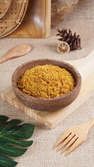 "Sambal Lingkung" is a typical food from Palembang, Indonesia. namely a type of floss made from catfish meat, in a wooden bowl photographed in the studio with a wooden theme prop
