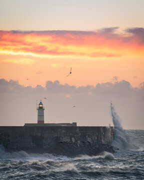 Strong December winds and tide at Newhaven lighthouse west beach on the east Sussex coast south east England UK