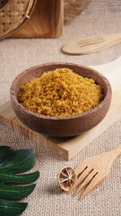 "Sambal Lingkung" is a typical food from Palembang, Indonesia. namely a type of floss made from catfish meat, in a wooden bowl photographed in the studio with a wooden theme prop
