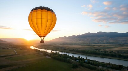 Obraz premium A Captivating Aerial View from Inside a Hot Air Balloon Over Scenic Mountains and a Serene River at Sunrise with Vibrant Colors in the Sky