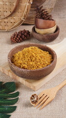 "Sambal Lingkung" is a typical food from Palembang, Indonesia. namely a type of floss made from catfish meat, in a wooden bowl photographed in the studio with a wooden theme prop