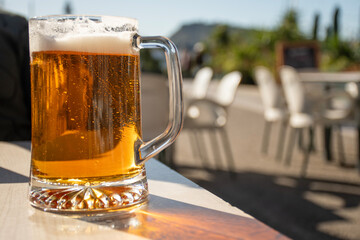 mug of beer on a sunny day in a close-up outdoor restaurant