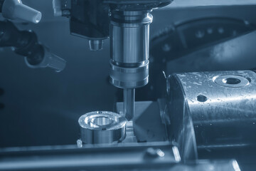 The CNC milling machine chamfer cutting part by chamfer tool in the light blue scene.