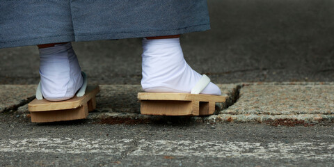 Closeup of feet dressing with geta ,traditional japanese wooden shoes