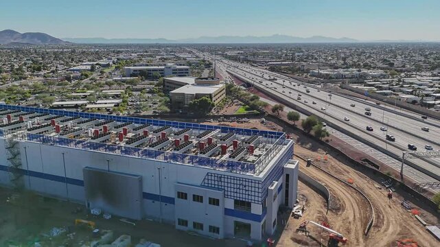 Hyperlapse drone shot of a new data center under construction and I-17 freeway in Phoenix, Arizona