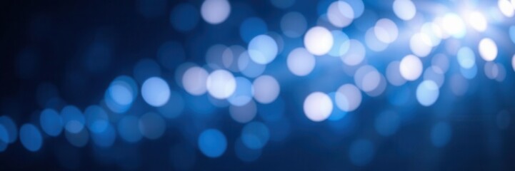 Obraz premium Beautiful abstract background with blue bokeh lights creating a dreamy and ethereal atmosphere perfect for enhancing design projects, wallpapers, or invitations.