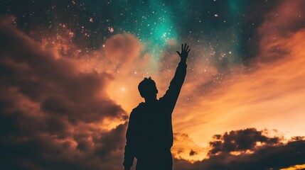 Fototapeta premium A silhouetted figure reaching for a starry sky at sunset, symbolizing aspiration and wonder.