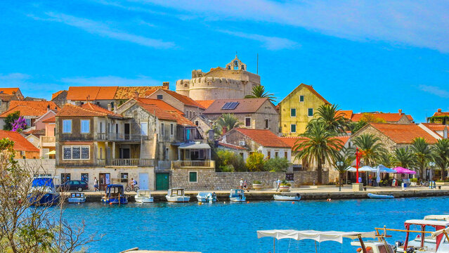 View of the monuments of Vrboska, attractions on the island of Hvar, moored boats in the bay