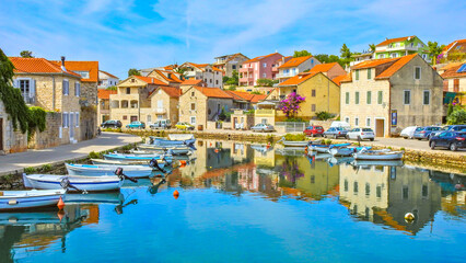 Obraz premium View of the monuments of Vrboska, attractions on the island of Hvar, moored boats in the bay