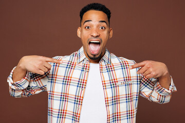 Young excited winner man of African American ethnicity he wear blue shirt casual clothes point...