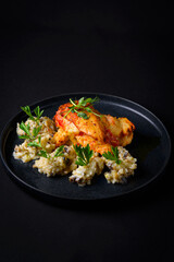 French chicken breast in a black plate
