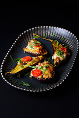 fried eggplant with cheese, tomatoes, green onions