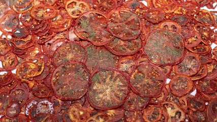 Dry tomatoes, tomato chips with herbs, delicious snack, healthy snack, selective focus