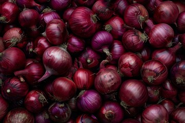 Close up of numerous red onions, creating a textured and colorful backdrop ideal for food related themes