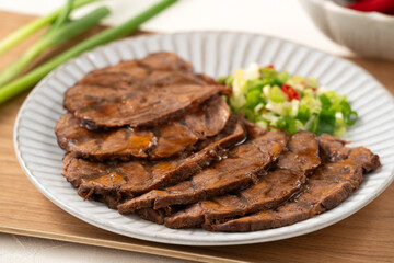 Taiwanese braised beef shank slices in a plate on white table background.