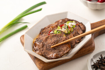 Taiwanese braised beef shank slices in a plate on white table background.
