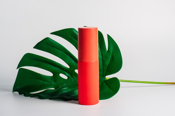 Cosmetic red bottle and hand, bottle, lotion or serum with palm on white background. 