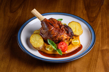 stewed lamb shank with pumpkin puree and baked potatoes