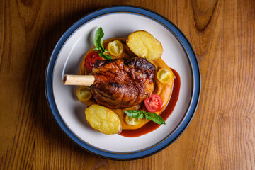 stewed lamb shank with pumpkin puree and baked potatoes