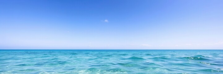 Obraz premium Tranquil Blue Ocean Water Surface Under Clear Sky with Soft Gentle Waves and Bright Sunshine Creating a Peaceful Summer Atmosphere for Relaxation and Reflection