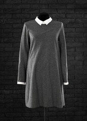 grey vintage classic dress on mannequin isolated on black background