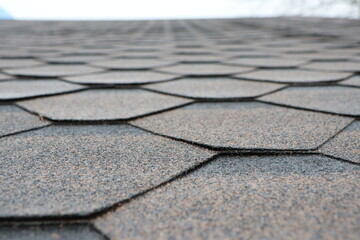 Closeup of a hexagonal asphalt shingle roof, showcasing craftsmanship and durability for homes