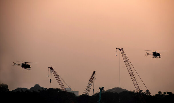 in a dock area to chopper is flying during dawn