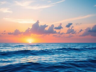 Obraz premium Serene Sunrise Over Calm Ocean Waves with Soft Clouds and Warm Colors Reflecting in the Water Creating a Peaceful Coastal Scene