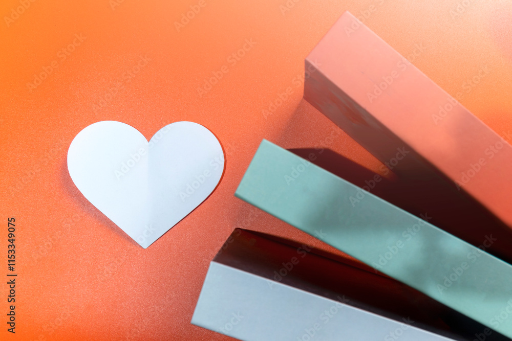 Poster top view of the white heart and a row of books on a colored background
