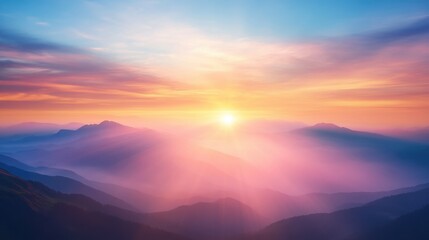Obraz premium Majestic sunset over misty mountain ranges.
