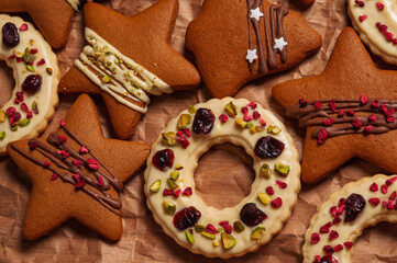 Festive gingerbread cookies shaped as stars and wreaths, beautifully decorated.
