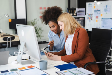 Diverse professionals collaborate on project analysis with financial graphs. Strategic teamwork and insights drive company growth and success.