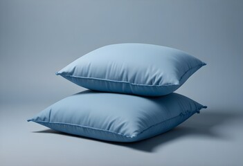 Two blue pillows on a plain background