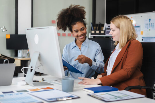 Diverse professionals collaborate on project analysis with financial graphs. Strategic teamwork and insights drive company growth and success.
