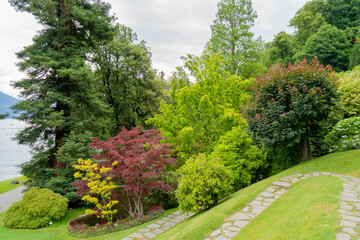 A beautiful garden landscape located right by a lake, surrounded by nature