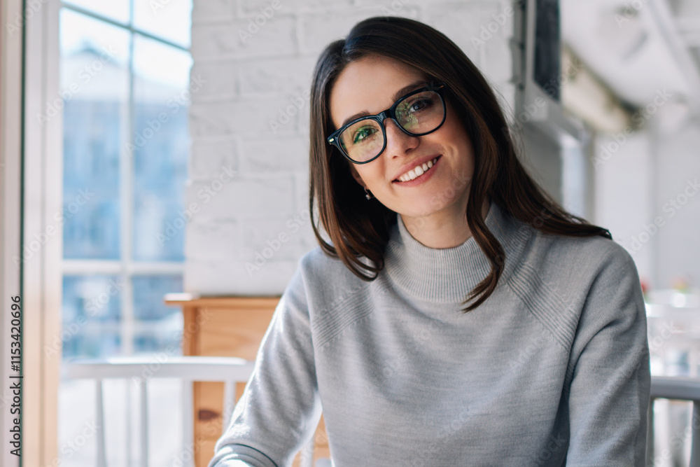 Poster portrait of young smiling woman looking at camera at cafeteria blogging via new telephone with 4g co
