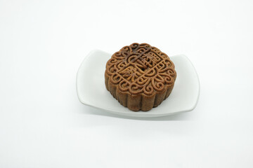 Traditional Chinese mooncake to celebrate the Middle Autumn Day isolated on a white background. Black sesame single yolk or Lotus single yolk flavor