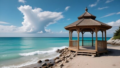 Fototapeta premium A gazebo on a sandy beach with turquoise blue water and a cloudy sky in the background