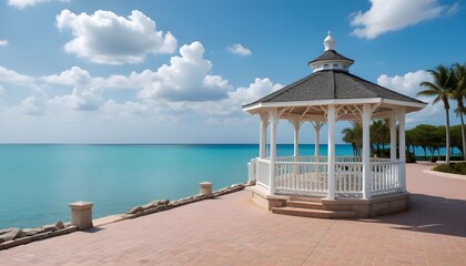 Obraz premium A gazebo on a paved plaza with turquoise blue water and a cloudy sky in the background