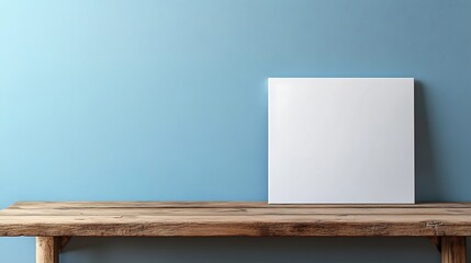 Fototapeta premium Clean Canvas Mockup: Wide Shot Photo of Blank Artwork on Rustic Wooden Table Against a Serene Blue Wall. AI Generated
