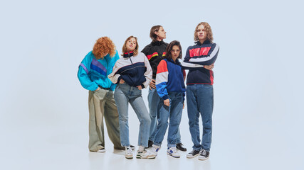 Group of young stylish people wearing retro-style jackets in bold colors, paired with jeans and...