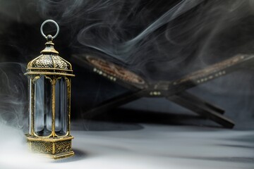 Arabic lantern and Quran matt on a black background. Decoration for Muslim holidays celebration