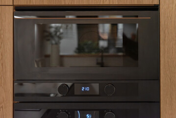 Built in microwave oven in the kitchen furniture, front view