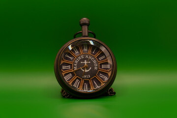 Vintage pocket watch with Marine Anchor design on green background