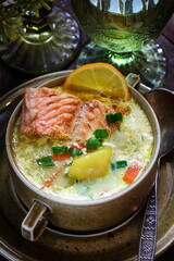 Creamy red fish soup on wooden background