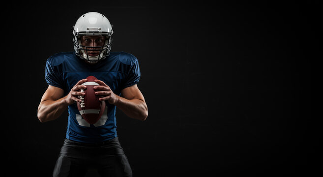 American football player, athlete holding ball in sport uniform on dark background for action. Man, team and professional game with equipment for training, practice or competition