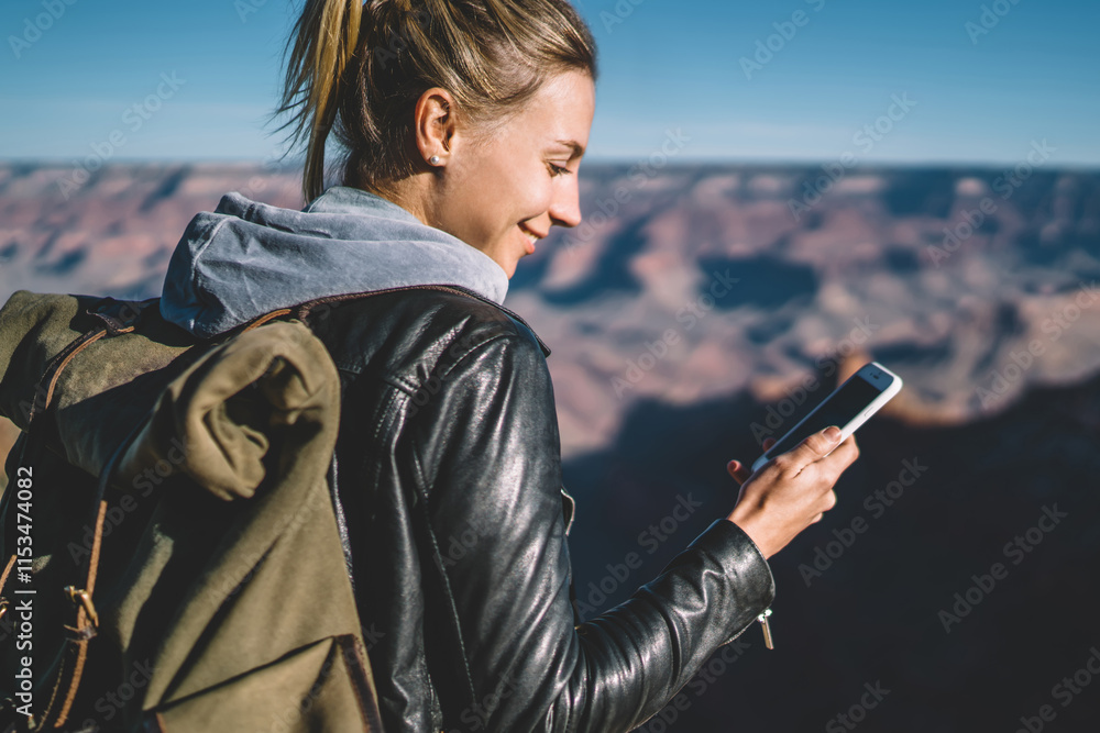 Poster smiling female tourist with backpack blogging in networks using good mobile connection in arizona na